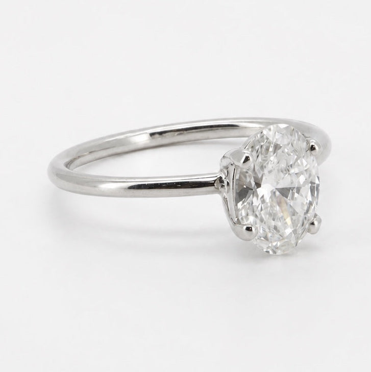 Oval solitaire ring in 14K gold, three-quarter view