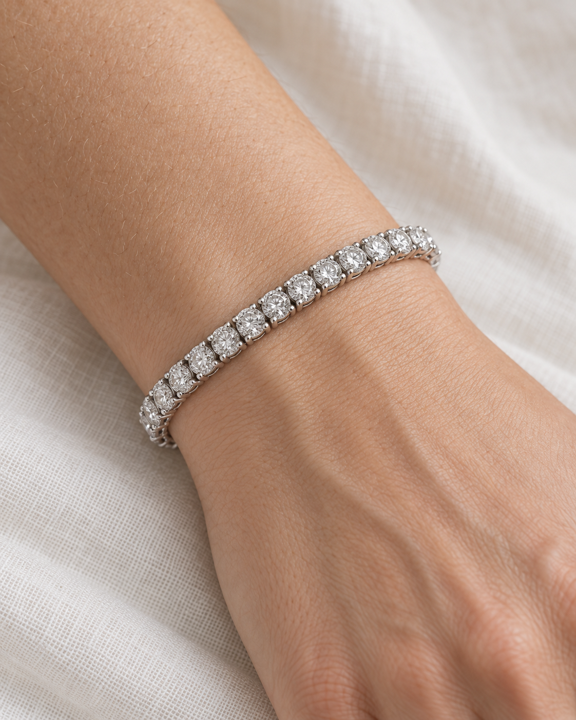 White-gold tennis bracelet worn on a wrist — AI-generated wearing illustration. SKU 10053. #Metal_14K White Gold
