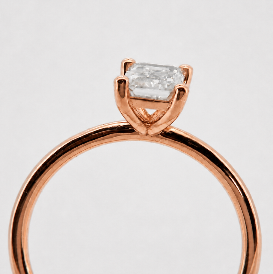 Rose-gold visualization of the emerald-cut solitaire engagement ring, end-on basket profile #Metal_14K Rose Gold