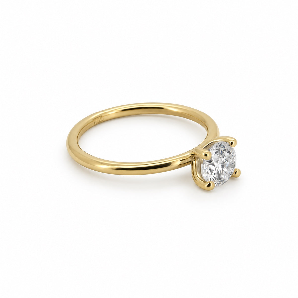Round solitaire engagement ring in 14K yellow gold, three-quarter view