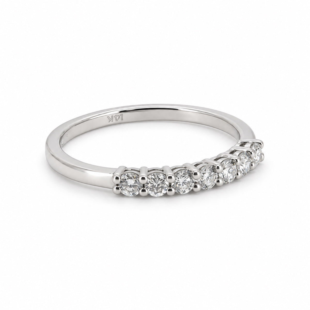 Seven-stone round ring in white-tone metal, front three-quarter view