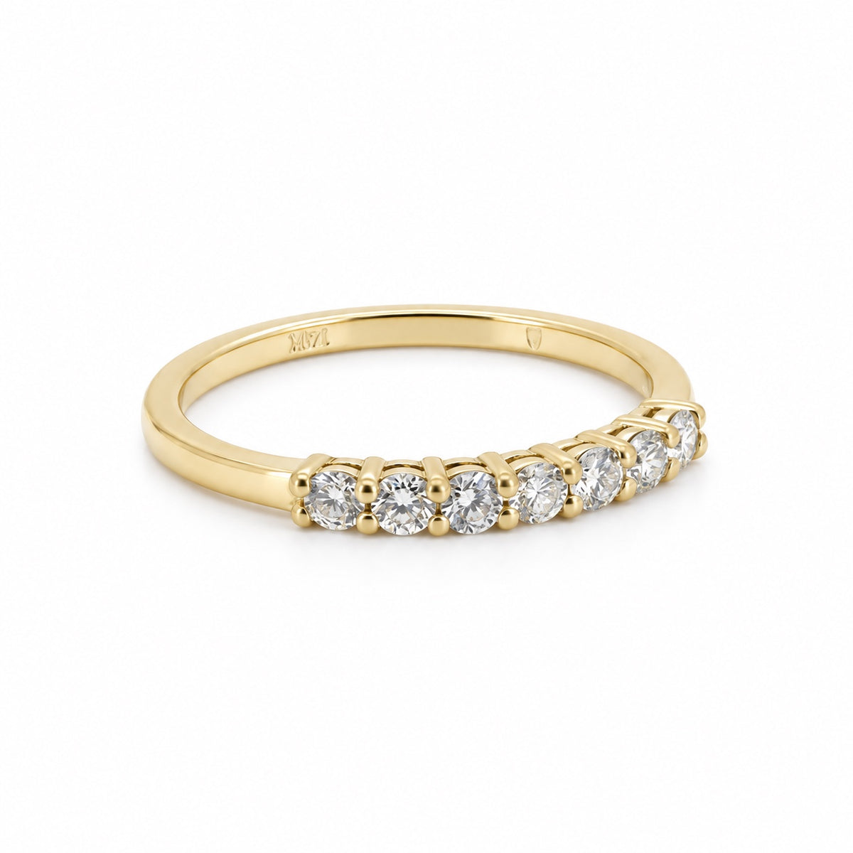 Seven-stone round ring in yellow-tone metal, front three-quarter view
