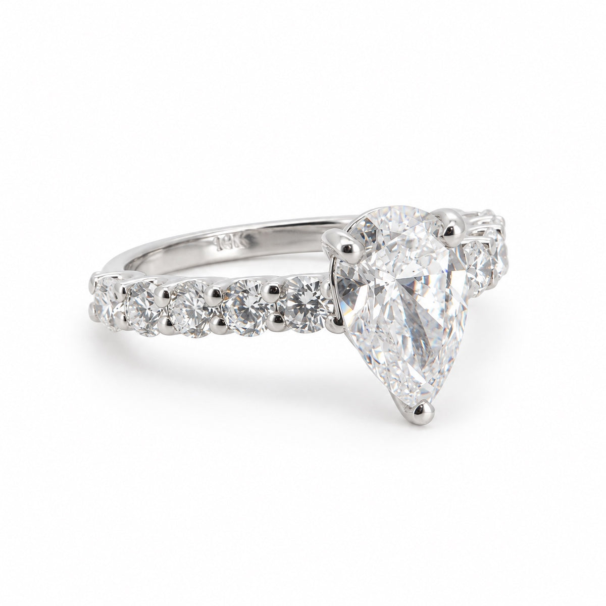 Pear solitaire engagement ring with stone-set band in 14K white gold, three-quarter view