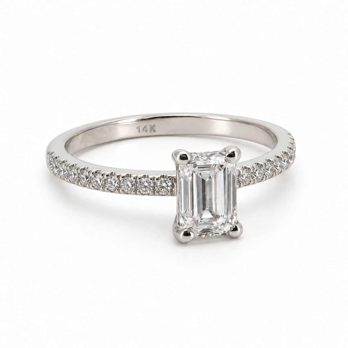 Emerald solitaire engagement ring with stone-set band in 14K white gold, three-quarter view