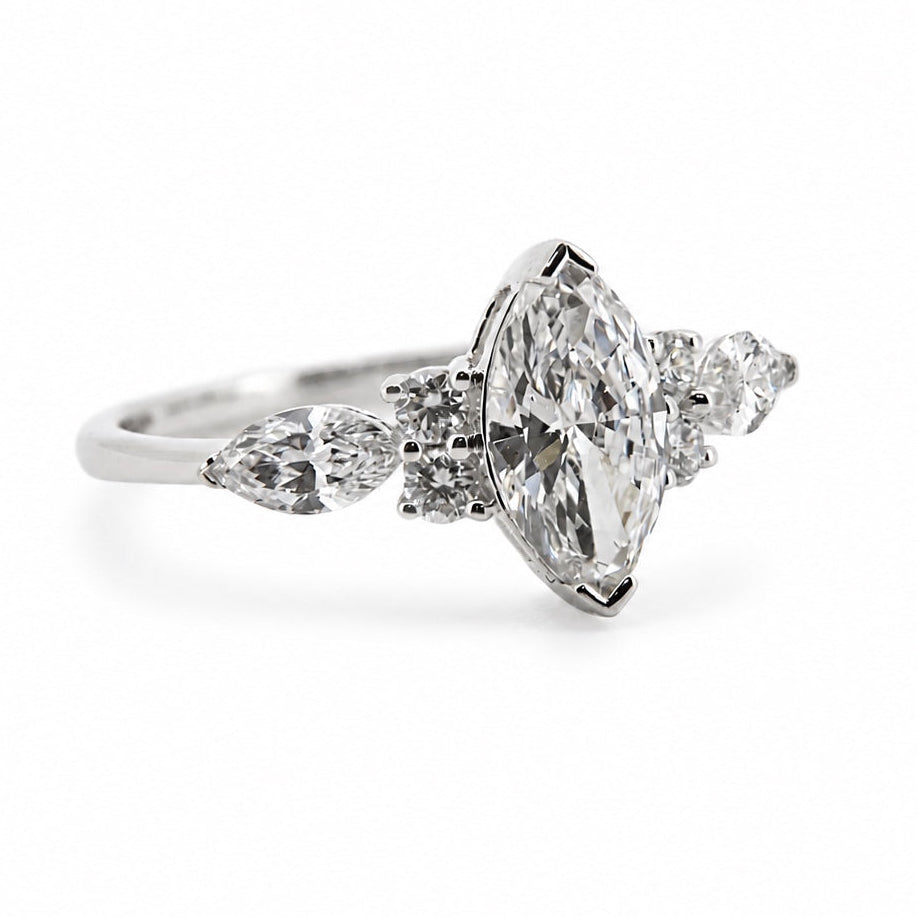 Left three-quarter view of the marquise and pear three-stone ring