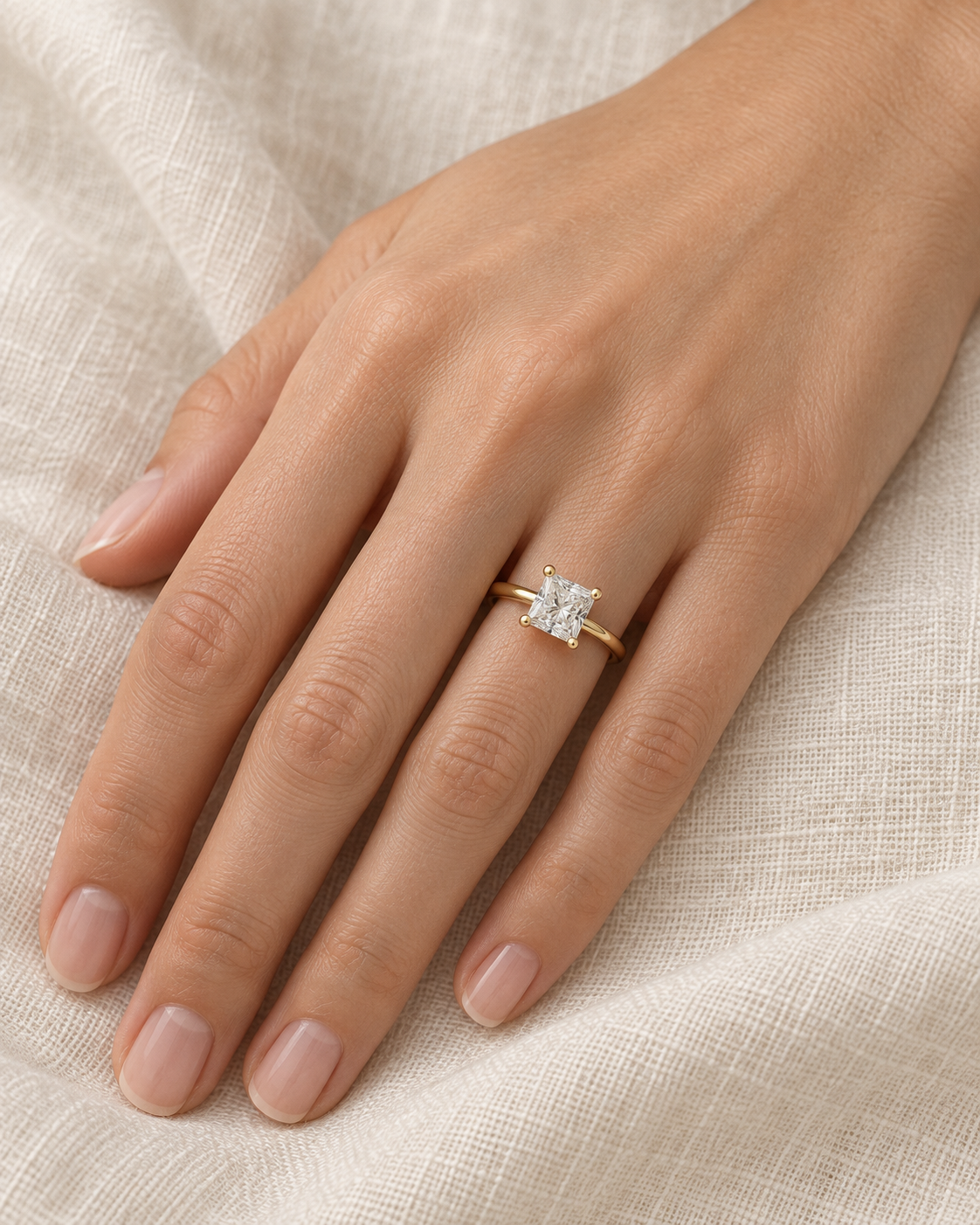 Yellow-gold princess solitaire ring worn on a hand — AI-generated wearing illustration. SKU 10050.