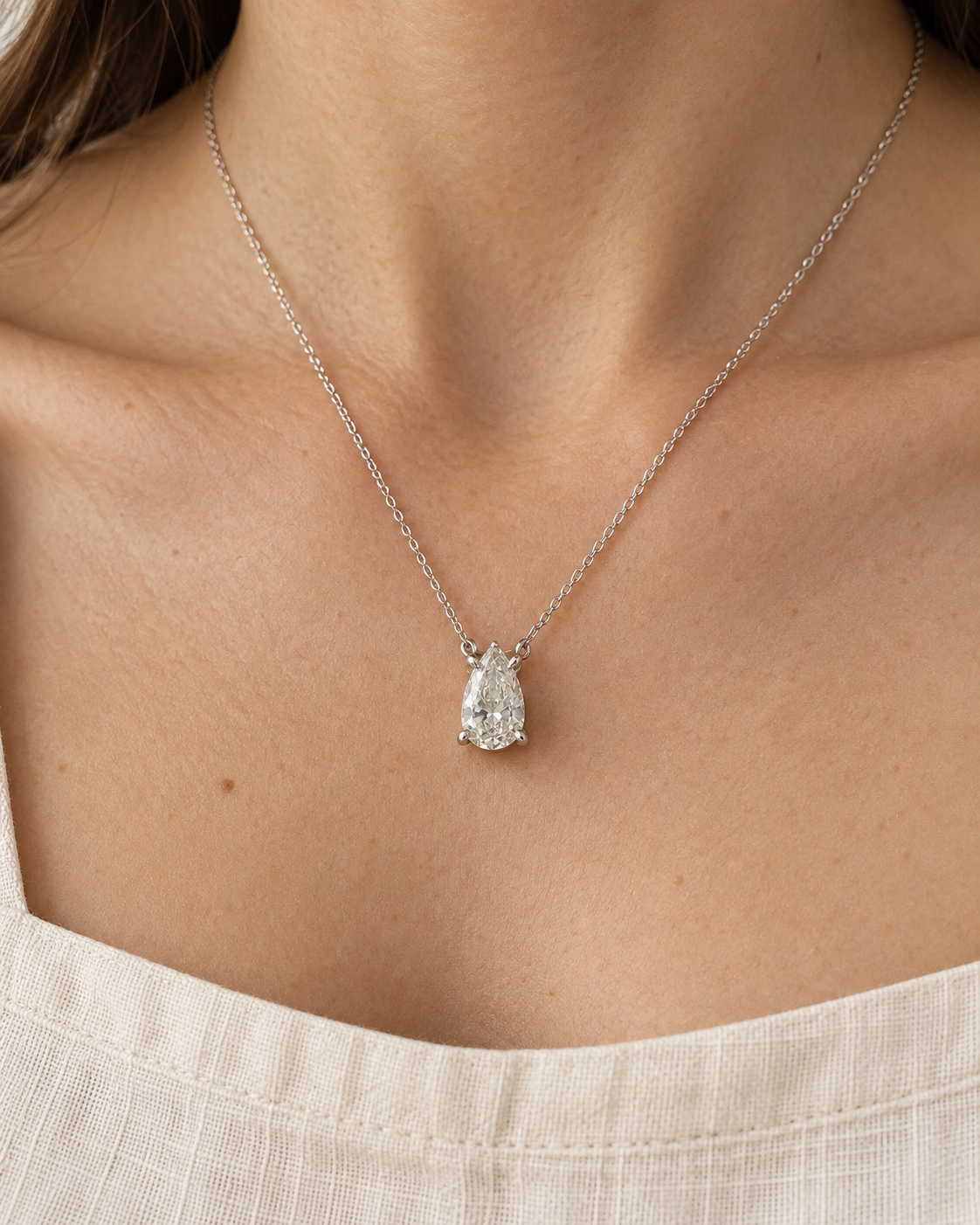 Pear solitaire necklace worn on the neck — AI-generated wearing illustration. SKU 10052. #Metal_14K White Gold