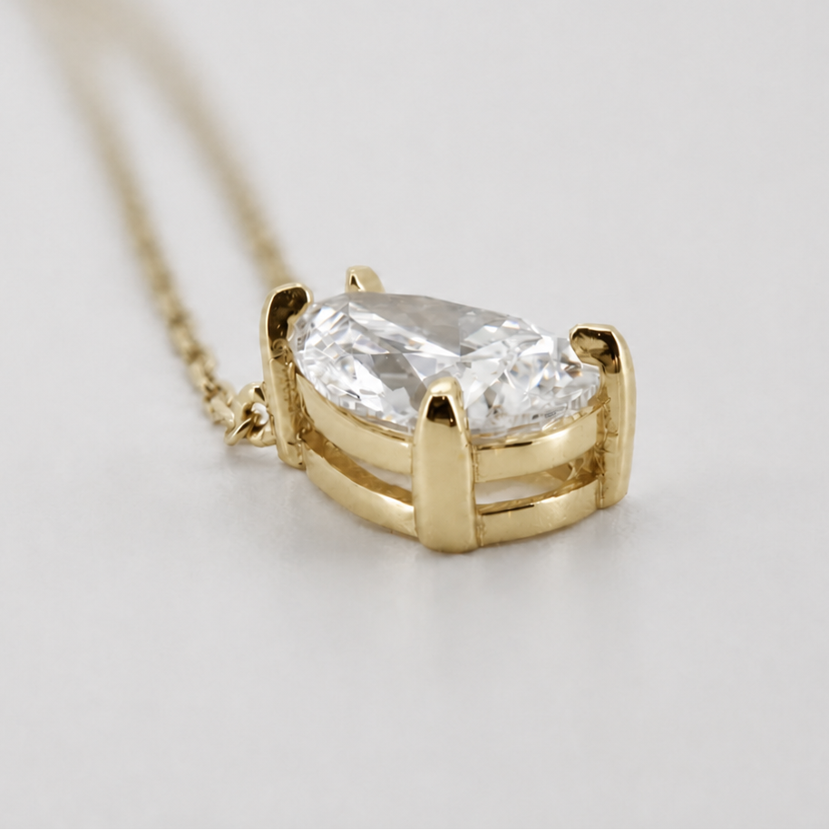 Yellow-gold visualization of the pear-cut diamond pendant necklace, three-quarter side profile #Metal_14K Yellow Gold