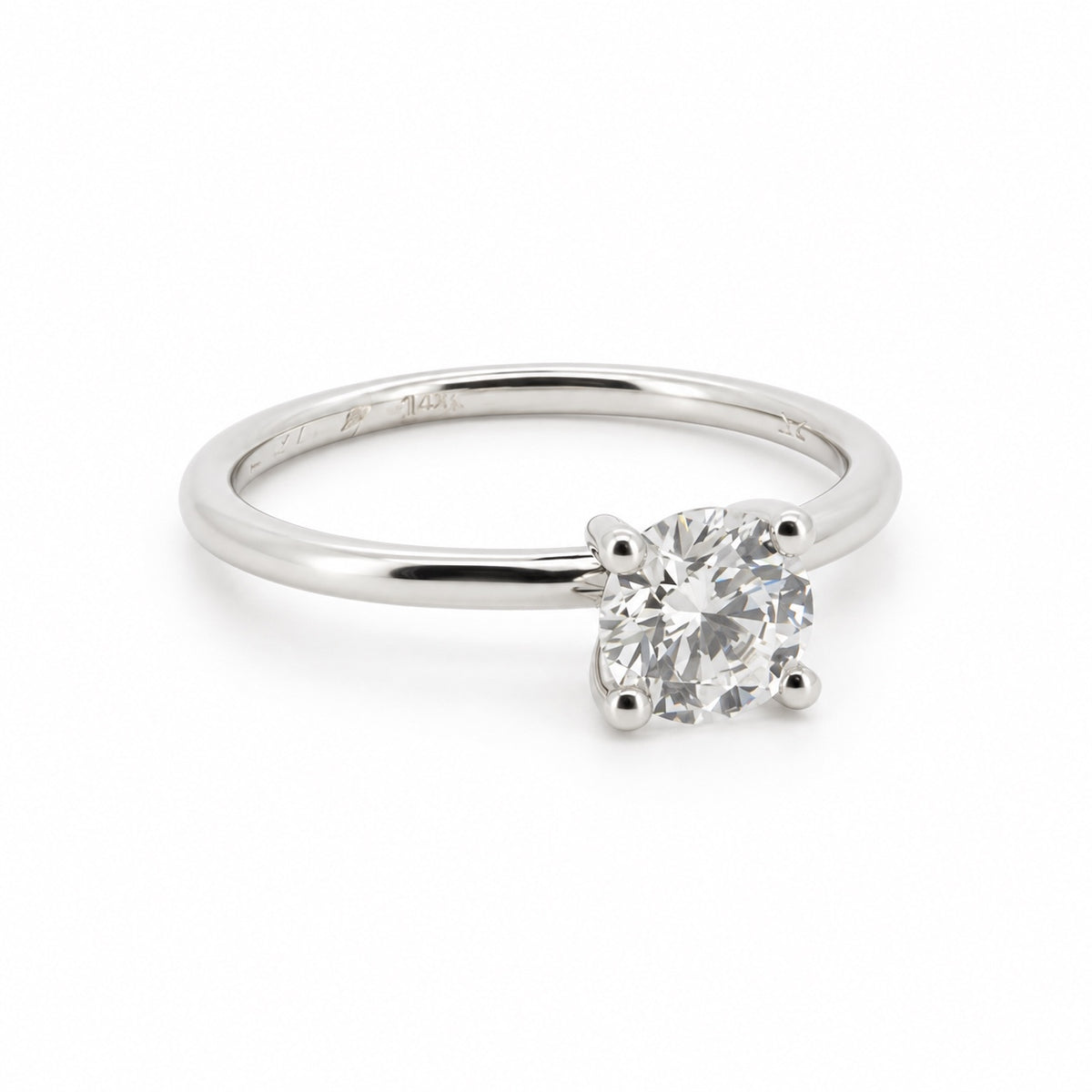 Round solitaire engagement ring in 14K white gold, three-quarter view