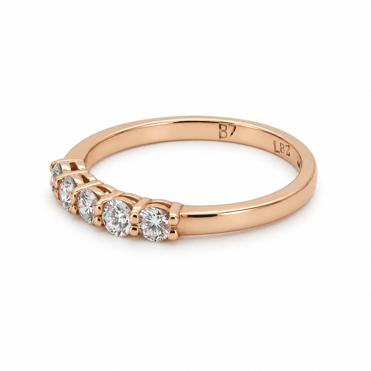 Five-stone round ring in rose-tone metal, front three-quarter view